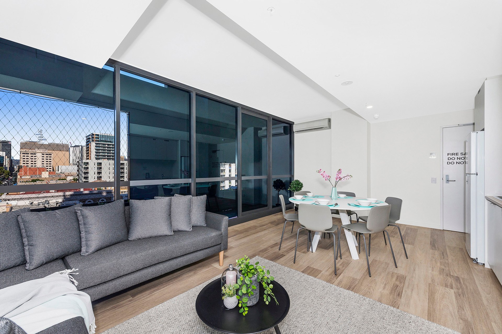 Shared living and dining area in 6 bed apartment at Scape Waymouth