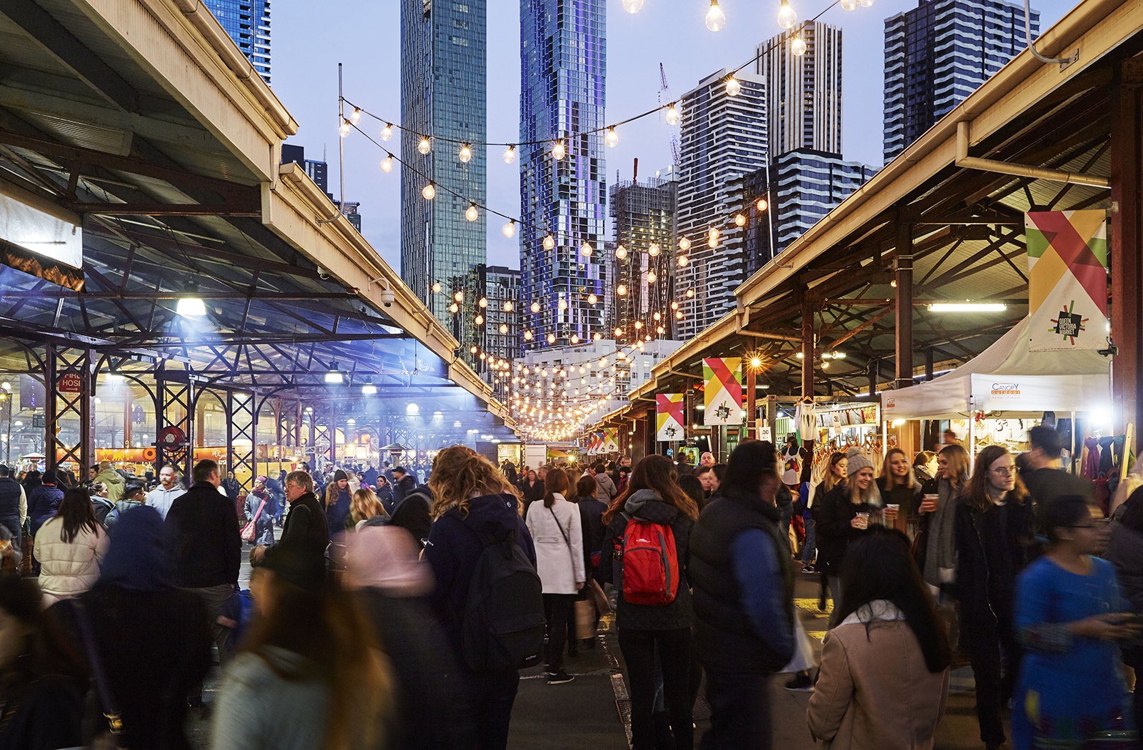 Crowd visiting markets under twin overpasses