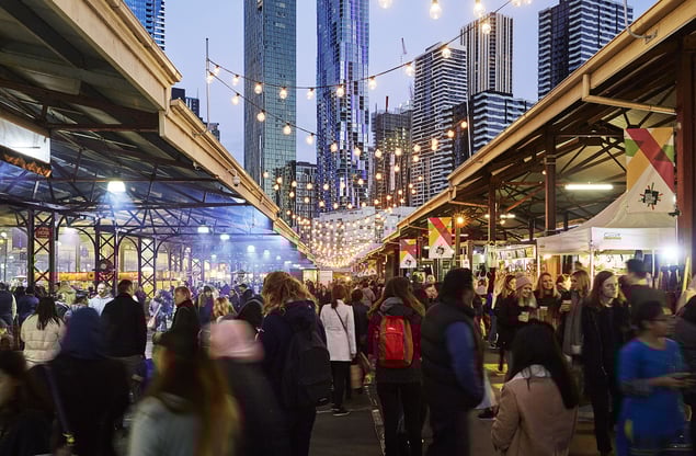 Crowd visiting markets under twin overpasses