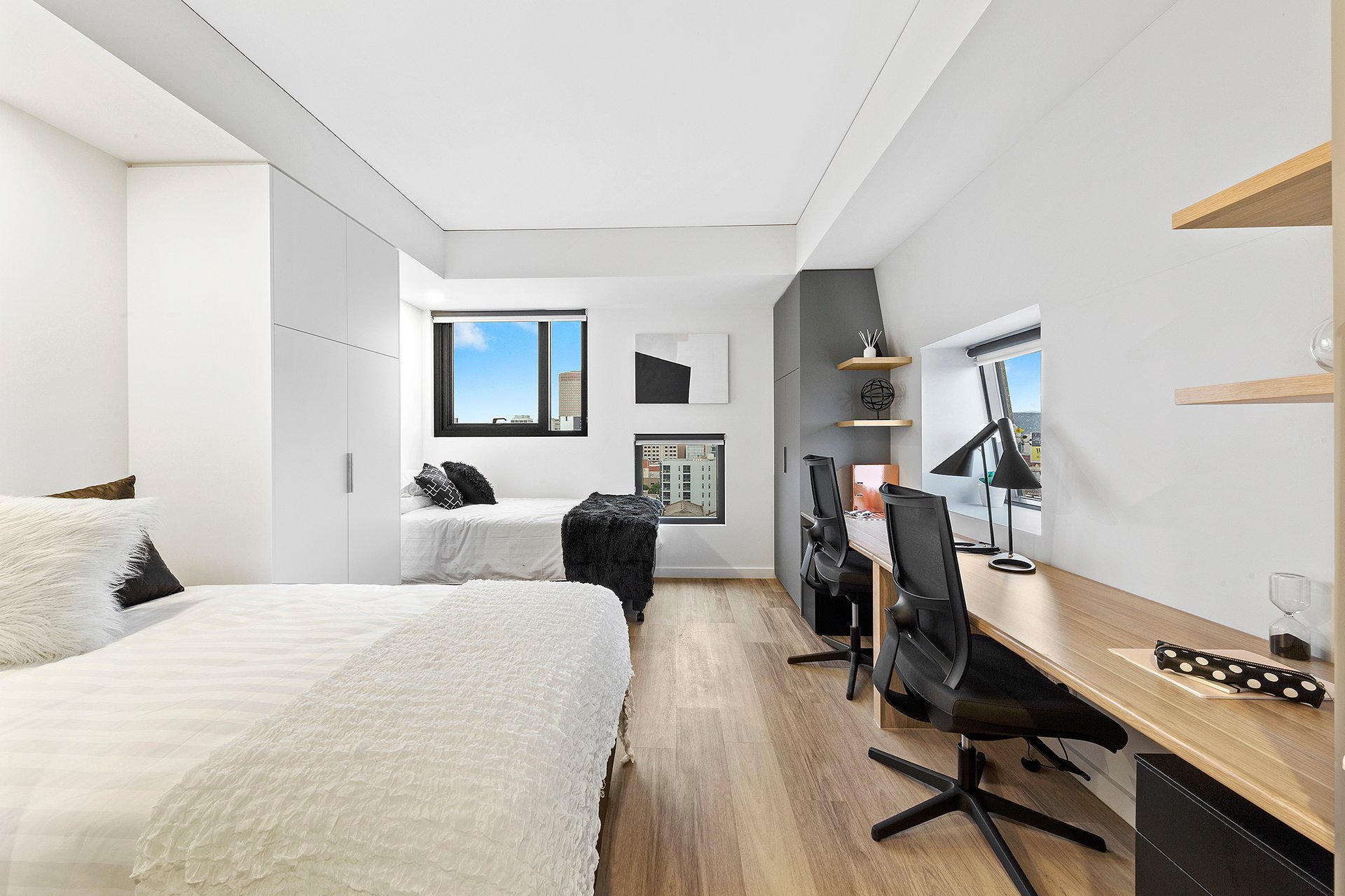 Desks and bed in the large twin apartment